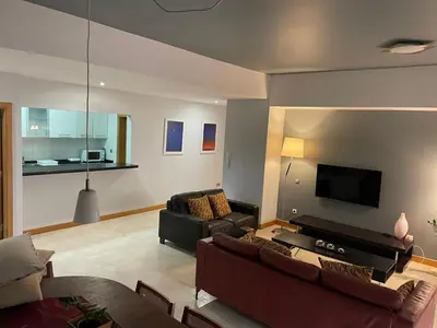 a living room with two couches and a flat screen tv at Marimar in Praia