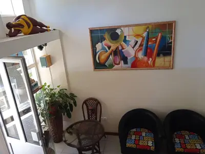 a living room with a painting on the wall at Atlantic Maio Hotel in Vila do Maio