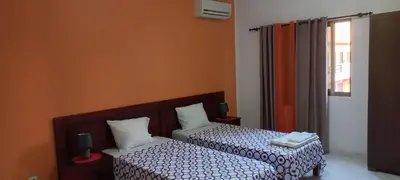 a room with two beds and a window at Ka-Bela 2 in Sal Rei