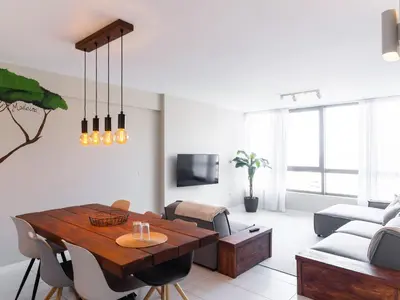 a living room with a table and a couch at Madeira apartment in Mindelo São Vicente in Mindelo