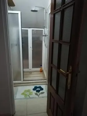 an open door to a bathroom with a shower backdoor at Casa Privada do Plateau in Praia