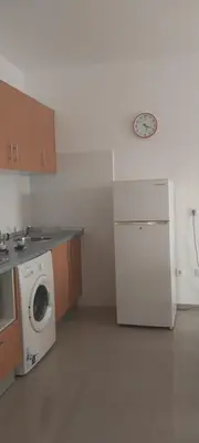 a kitchen with a white refrigerator and a washing machine at Ca’ Tina in Santa Maria
