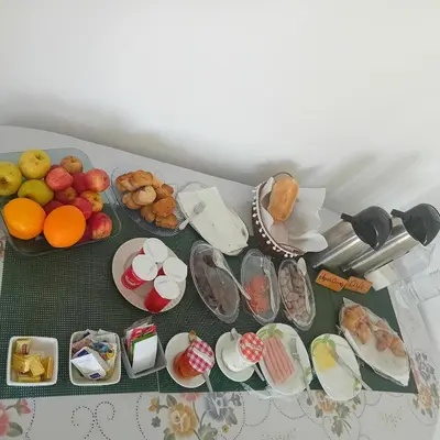 a table topped with plates of food and fruit at Residencial Rosa Criola in Sal Rei