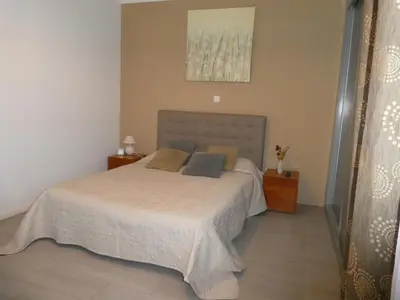 a bedroom with a bed and a painting on the wall at Praia Center in Praia