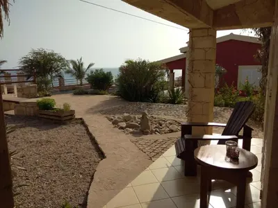 a patio with a table and chairs and the ocean at Casita Solemar direkt am Atlantik in Vila do Maio