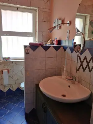a bathroom with a sink and a mirror at Casita Solemar direkt am Atlantik in Vila do Maio