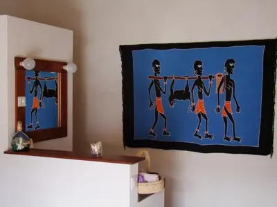 a painting of two people doing a pull up hanged on a wall at Villa Morabeza Guest House in Mindelo