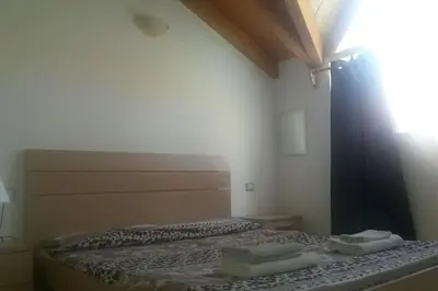 a bedroom with a bed with two towels on it at Holiday Properties Soleil Penthouse in Santa Maria