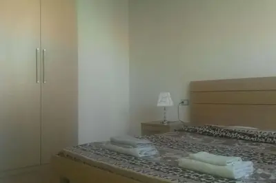a bedroom with a bed with two towels on it at Holiday Properties Soleil Penthouse in Santa Maria