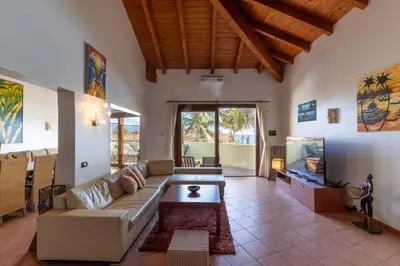 a living room with a couch and a table at Porto Antigo 1 - Three bedroom, pool & wifi in Santa Maria