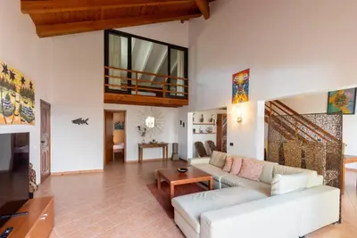 a living room with a couch and a table at Porto Antigo 1 - Three bedroom, pool & wifi in Santa Maria