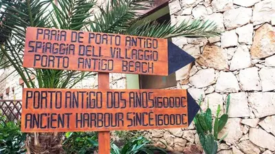 two street signs in front of a stone wall at Porto Antigo 1 - Three bedroom, pool & wifi in Santa Maria