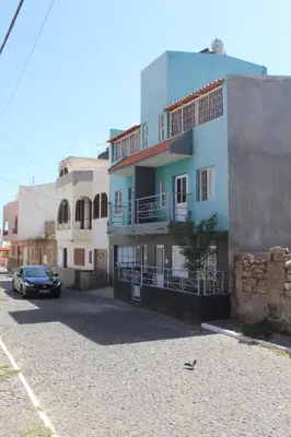 a building with a car parked in front of it at SAM House in Mindelo
