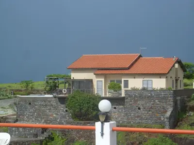 a house on top of a stone wall at Villa Halcyon cabo verde close to the beach in Cidade Velha