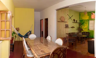 a dining room with a wooden table and chairs at Casa Matnik in Mindelo
