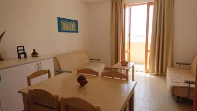 a living room with a table and a living room with a couch at Residence Estrela do Mar in Sal Rei