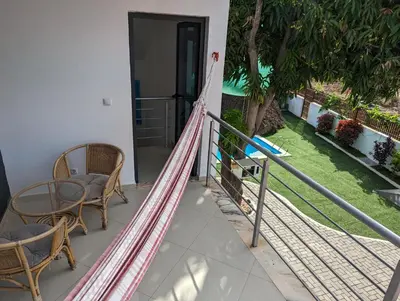 a hammock on the front porch of a house at Finca Pedra Molar in Órgãos