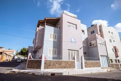 a large white building on the side of a street at Studio Maya Mindelo in Mindelo