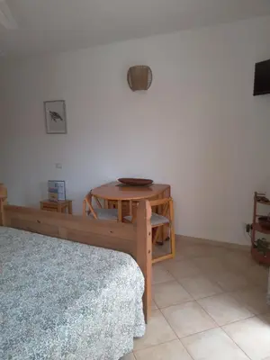 a room with a bed and a table and a table at Oasis Palmeira in Santa Maria