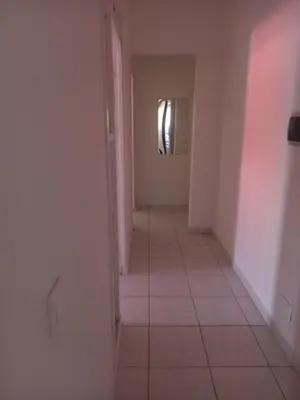 an empty hallway with a tile floor and a window at CHEZ LU & LUCIO in Assomada