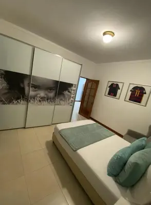 a bedroom with a bed and pictures on the wall at Residence Fazenda - Piscina in Praia