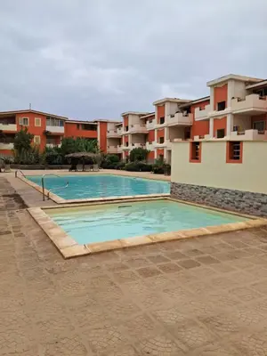 a swimming pool in front of some apartment buildings at MORADIAS I02/C in Prainha