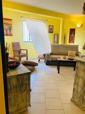 a living room with a couch and a table at Holiday Properties Casa Laranja in Santa Maria