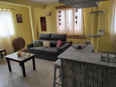 a living room with a couch and a table at Holiday Properties Casa Laranja in Santa Maria