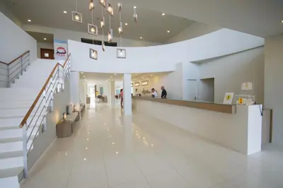a lobby of a building with a staircase and people at Oasis Belorizonte in Santa Maria