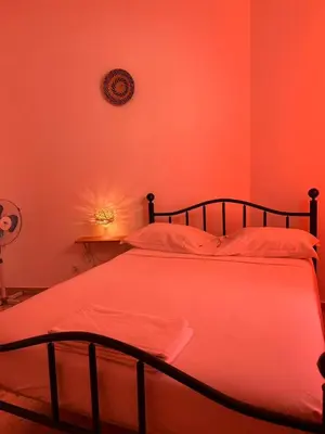 a bed in a room with an orange room at Tarrafal Ecodécor Rooms in Tarrafal