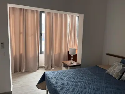 a bedroom with a bed and a large window at Casa Mar e Sol - Murdeira - Ilha do Sal in Palha Verde