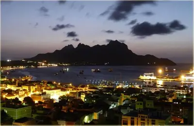 a view of a city at night with a mountain at Solar Windelo in Mindelo