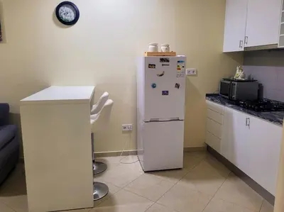 a kitchen with a white refrigerator and a counter at Castelinho Sal Lodge in Espargos