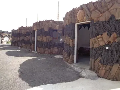 a stone building with a door in the side of it at Pensao Zé Doce in Portela