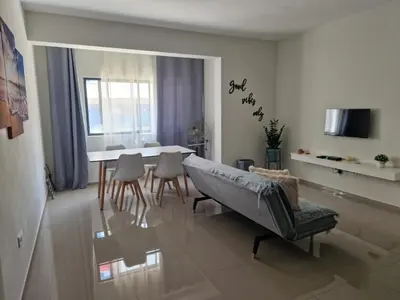 a living room with a table and chairs and a dining room at Apartamentos Beira-Mar in Mindelo