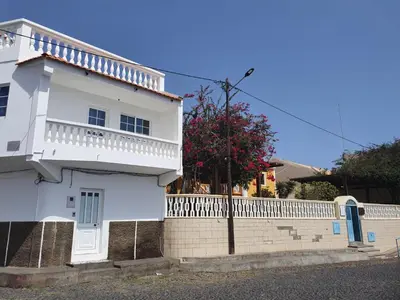 a white house with a white fence at Seaview Apartment in Tarrafal