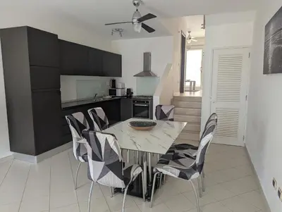 a kitchen and dining room with a table and chairs at Large Townhouse close to Beach in Sal Rei