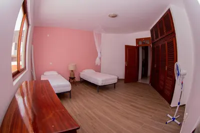 a small room with two beds and a table at Villa PalMarina in Praia