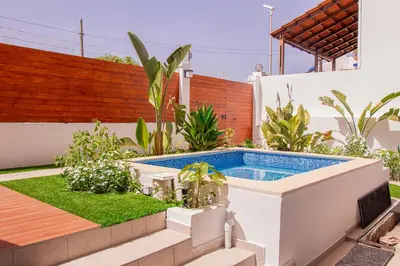 a swimming pool in the backyard of a house at Villa PalMarina in Praia
