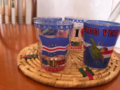 three blue cups sitting on top of a wooden table at Casa Andrade Delgado - Rocha Grande in Ponta do Sol