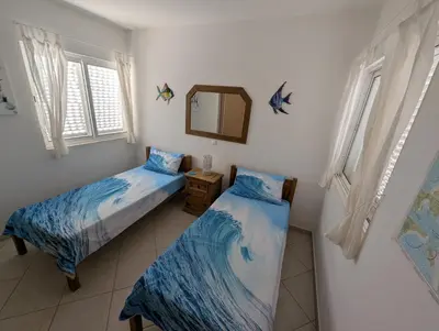 a bedroom with two beds and a mirror at Vista Oceano - Boa Vista Island in Sal Rei