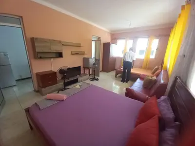 a man is standing in a living room at Casa Barreto in Tarrafal