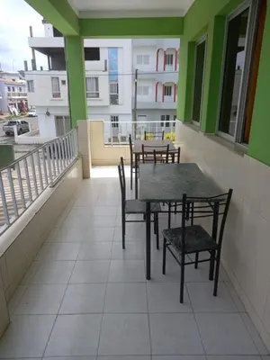 a table and chairs on the balcony of a building at Casa Barreto in Tarrafal