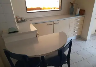 a table and chairs in a kitchen with a mirror at Lalas ASA in Praia