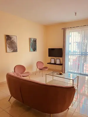 a living room with a glass table and chairs at Good Dreams Apartment in Praia