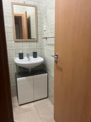 a bathroom with a sink and a mirror at Good Dreams Apartment in Praia