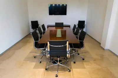 a conference room with a large wooden table and chairs at Hotel Pérola in Praia
