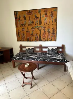 a bed in a room with a painting on the wall at KatlantiK Estoril Deluxe in Sal Rei