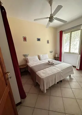 a bedroom with two beds and a ceiling fan at KatlantiK Estoril Deluxe in Sal Rei