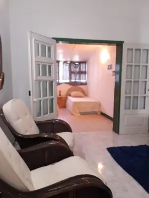 a room with a bedroom with a bed and a couch at Vila Paradise Sea & Swimming Pool View in Beirona